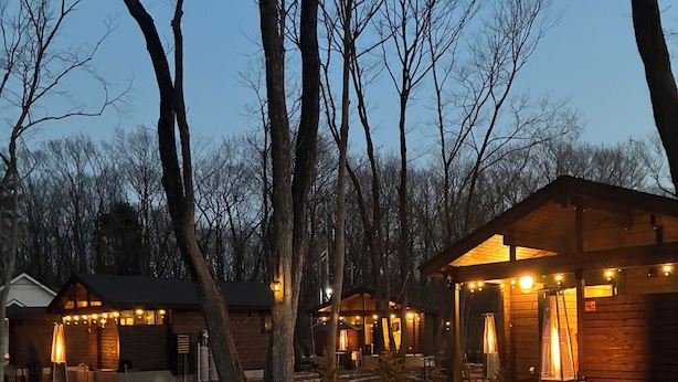 A rustic cabin with a wooden exterior, a porch, and a stone pathway. - mokku (Nasu)