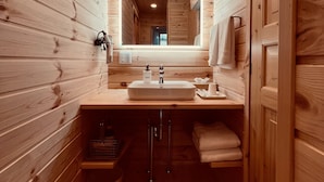 A wooden cabin interior with a sink, mirror, and towel rack. - mokku (Nasu)