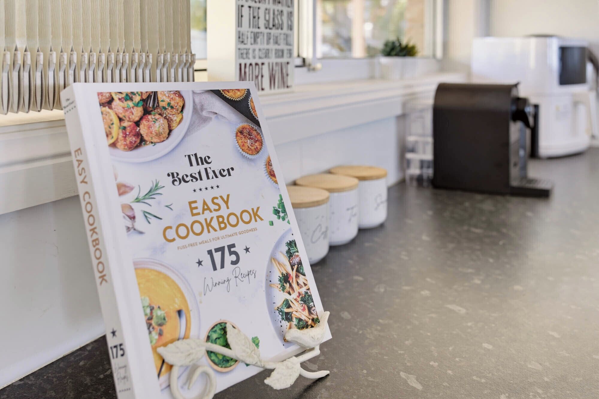 A promotional display for 'The BestEver EASY COOKBOOK' featuring 175 winning recipes.