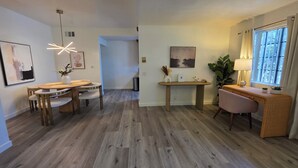Ein modernes Interieur mit Essbereich, Arbeitsplatz und großem Fenster.