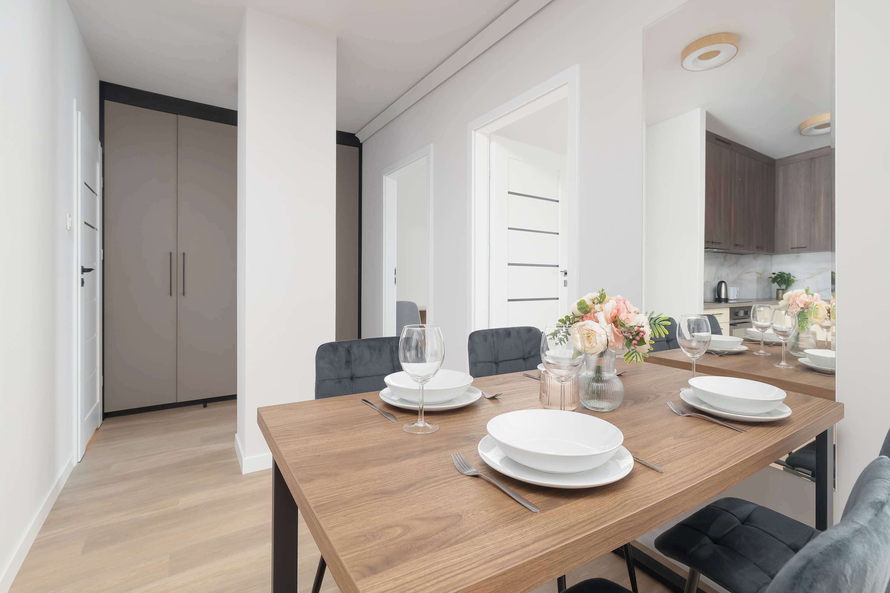A stylish dining table set for four guests next to the open-plan kitchen. It's a great place to enjoy breakfast, lunch, or dinner together.