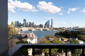 A city skyline with modern buildings and a river.