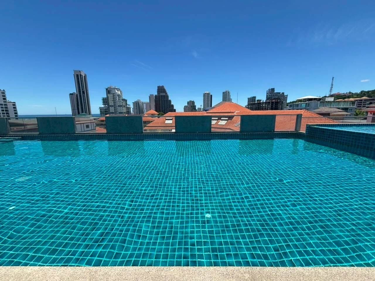 A rooftop pool with a cityscape view.