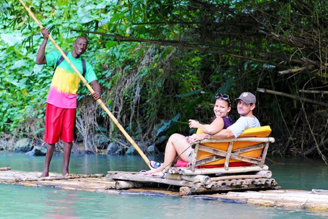 A couple on a small boat with a guide standing nearby.