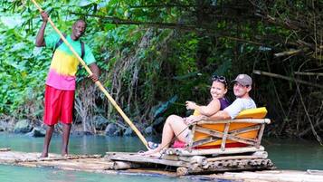 A couple on a small boat with a guide standing nearby.