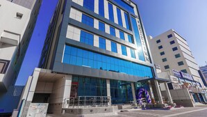 A multi-story hotel with a modern facade, large windows, and a prominent entrance area.