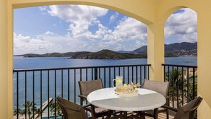 A balcony with a round table, chairs, and a pitcher of lemonade. - St. Thomas 2BR Oceanside Villa at Marriott’s Frenchman’s Cove – Beach & Resort A (Southside)