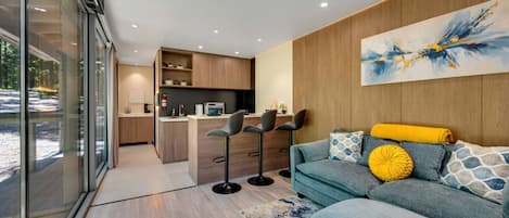 A modern interior with a kitchen, dining area, and living room.