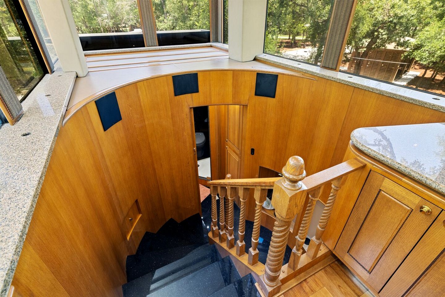 A wooden staircase with a curved design, leading to a lower level.