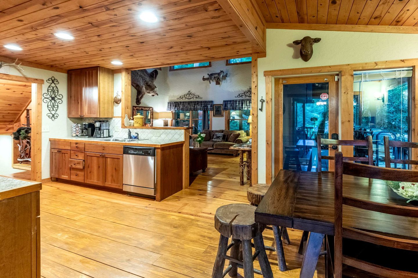 A wooden interior with a kitchen, dining area, and living room.