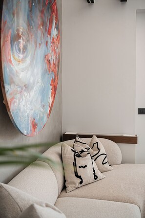 A modern bedroom with a bed, pillows, and a large abstract painting on the wall. - Cosmos Penthouse Suite (Chania)