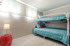 A bunk bed room with a lamp and a red chair. - Family-Friendly Home with Fire Pit & Cozy Fireplace in Coeur d'Alene, Idaho (Coeur d'Alene)