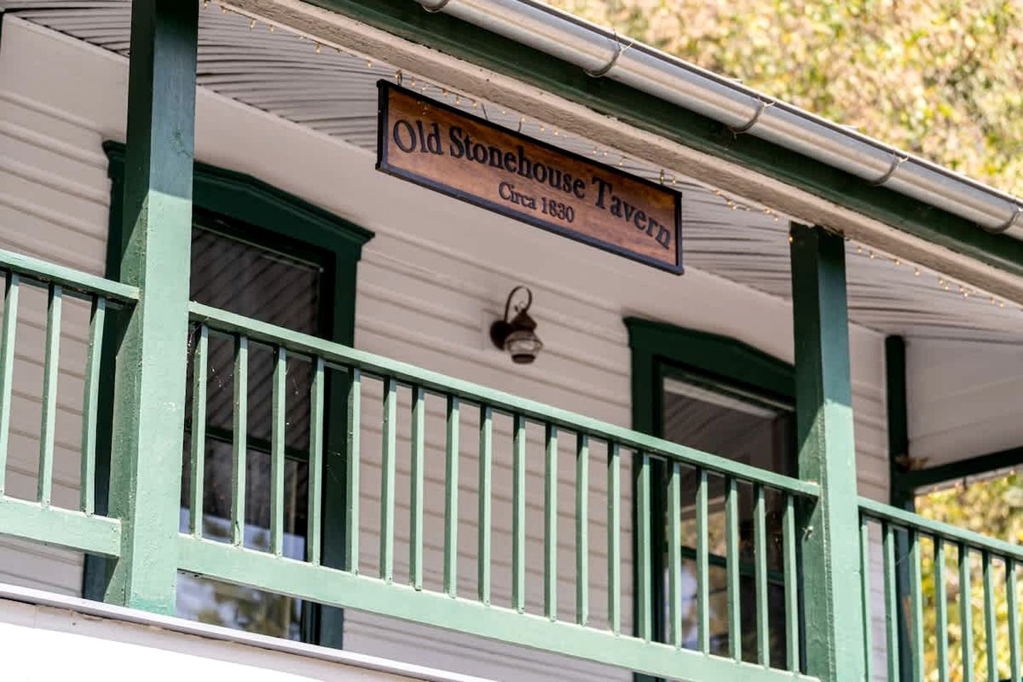A building with a sign that reads 'Old Stonehouse Tavern' and 'Office 1830.'