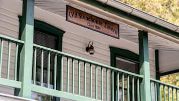 A building with a sign that reads 'Old Stonehouse Tavern' and 'Office 1830.'