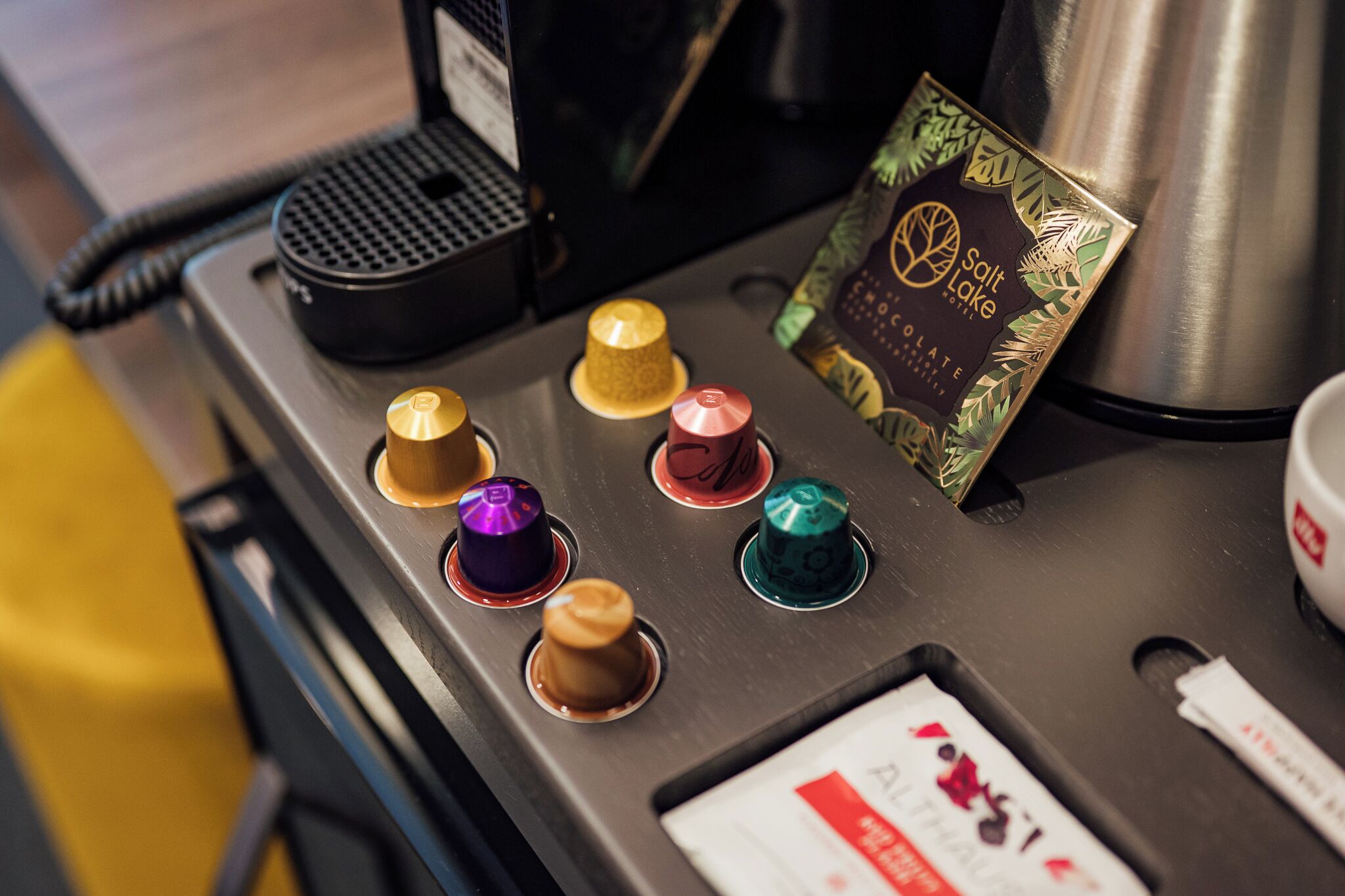 A coffee machine with multiple buttons and a salt and pepper shaker.