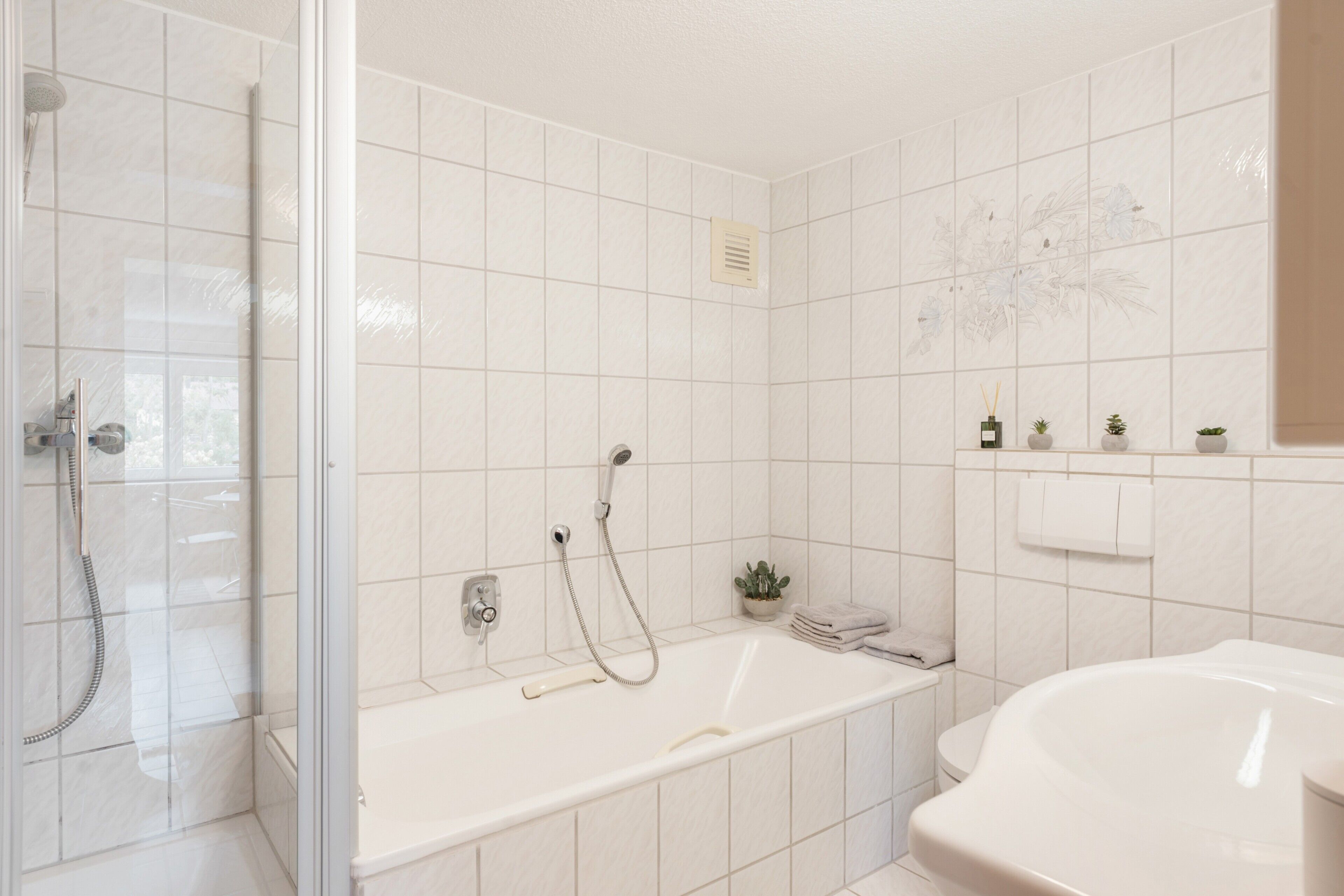 Ein Badezimmer mit Dusche, Badewanne und Toilette.