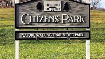 A sign for Citizens Park, indicating it is a nature walking trail and dog park.