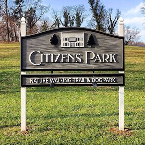 A sign for Citizens Park, indicating it is a nature walking trail and dog park.