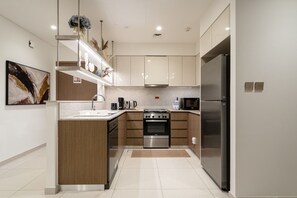 Eine moderne Küche mit einer zentralen Kochinsel, Edelstahlgeräten und minimalistischem Design.