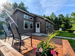 A house with a deck, two chairs, and a potted plant. - Peaceful Garden Retreat Near Acadia National Park, Maine (Ellsworth)