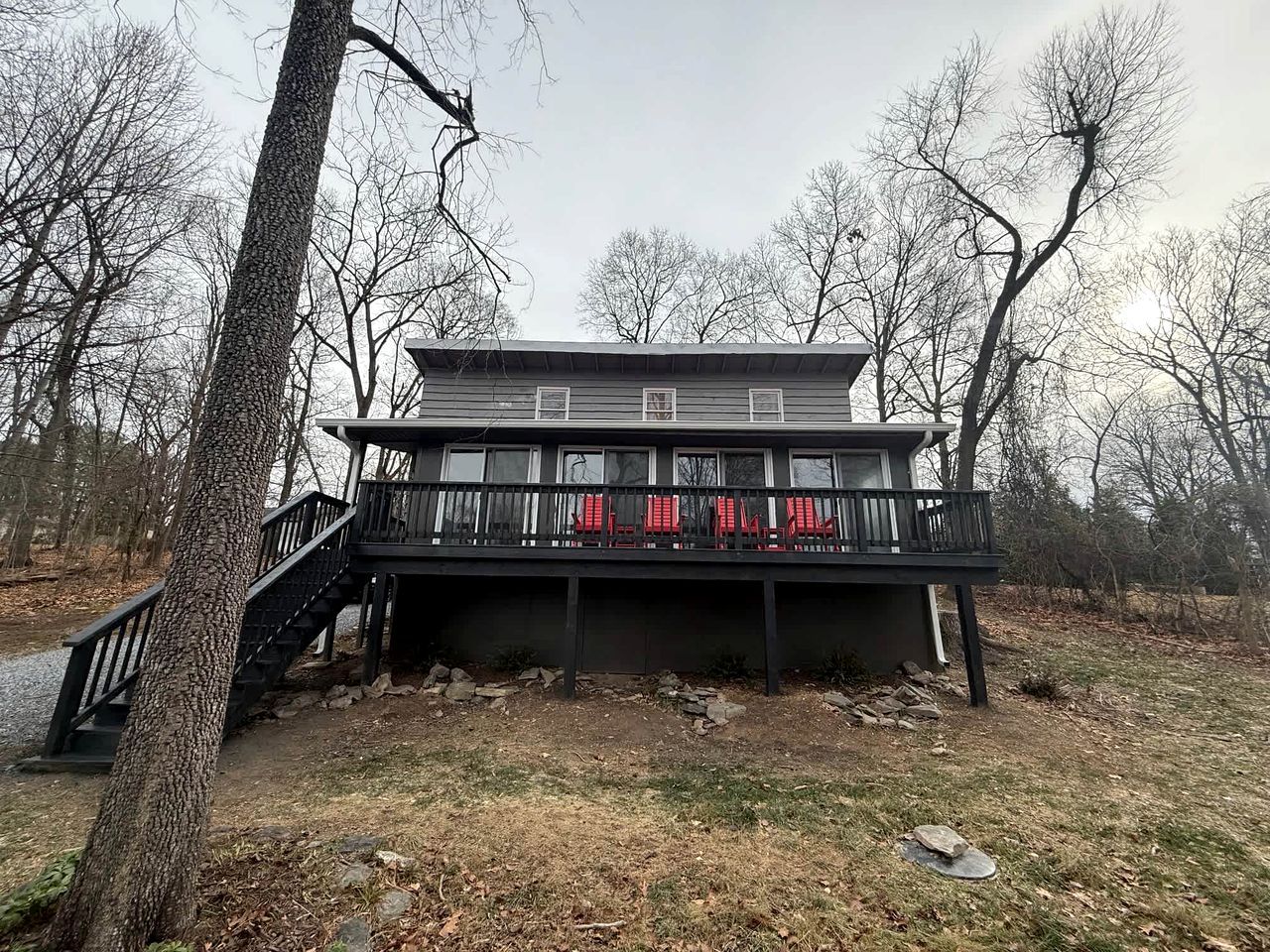 A two-story building with a balcony, a staircase, and a deck area.