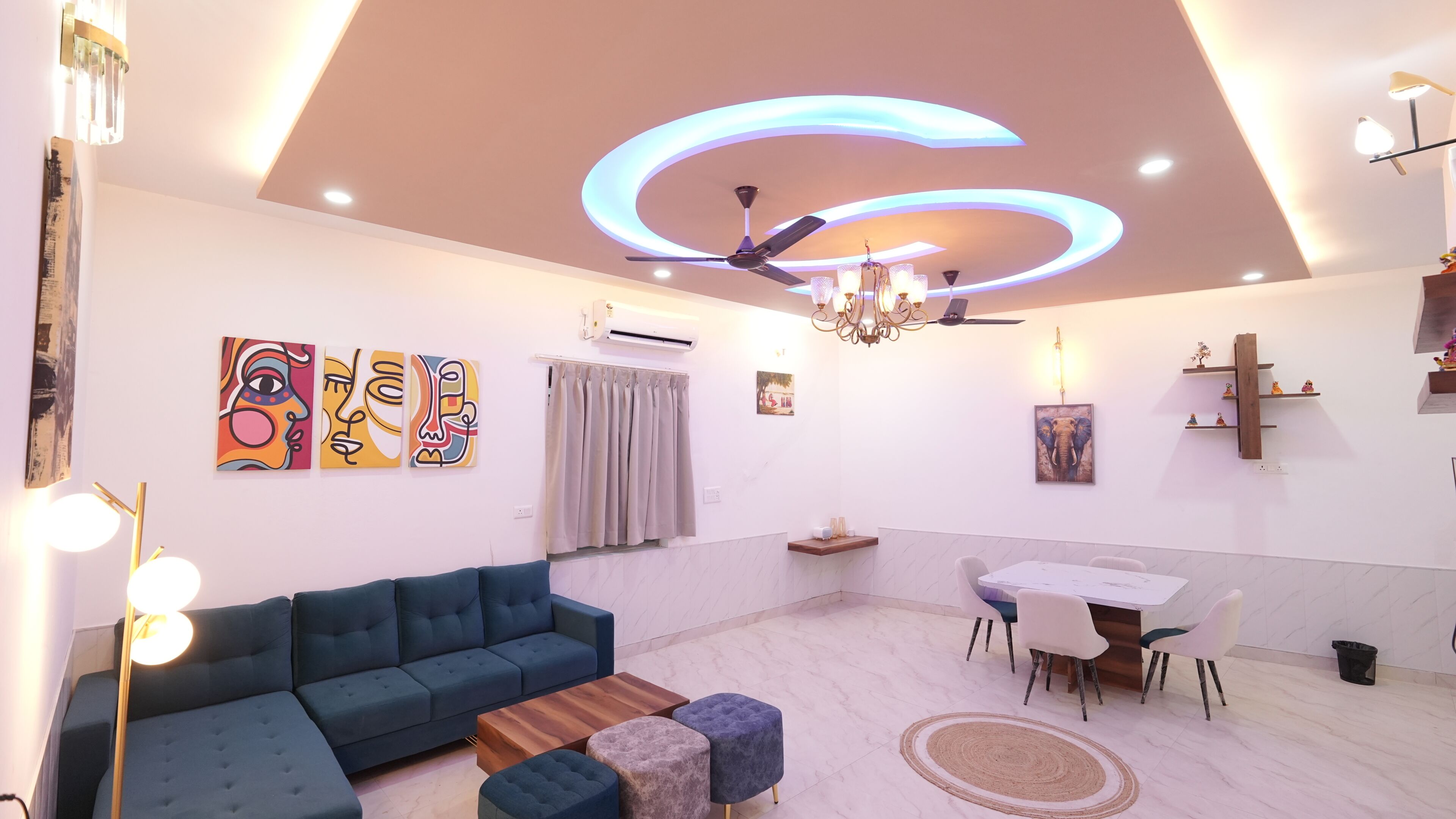A modern living room with a sofa, coffee table, and dining area.