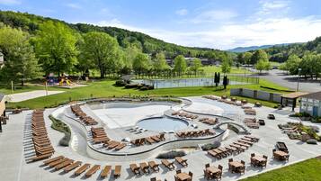 A pool area with sun loungers and a children's play structure.