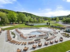 A pool area with sun loungers and a children's play structure. - Family Friendly Shenandoah Cabin with Fire Pit and Game Room in Basye Virginia (Basye)