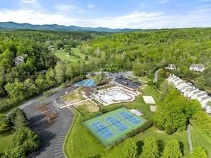 An aerial view of a golf course with a tennis court, parking areas, and residential buildings. - Family Friendly Shenandoah Cabin with Fire Pit and Game Room in Basye Virginia (Basye)