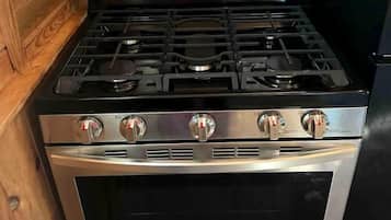 A stainless steel kitchen with a built-in oven and a digital control panel.