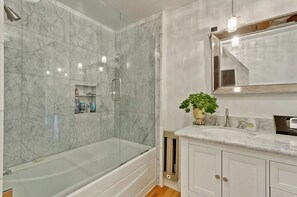 A bathroom with a glass-enclosed shower, a marble-tiled wall, a sink with a mirror, and a potted plant. - Terrific 6-bedroom house with AC in peaceful Historic downtown Palo Alto (Palo Alto)