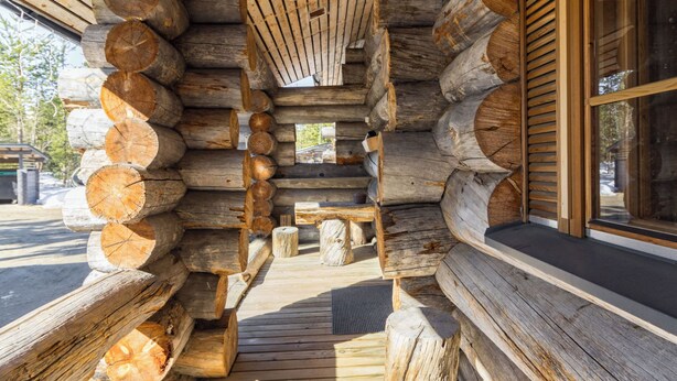 A log cabin with a wooden deck and a window. - Luostonseita 2 by Interhome (Sodankylä)