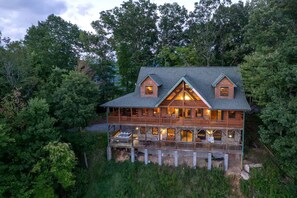 A large wooden cabin with multiple balconies, surrounded by dense forest. - Spacious Smoky Mountain Cabin with Hot Tub & Game Room near Waynesville, NC (Waynesville)