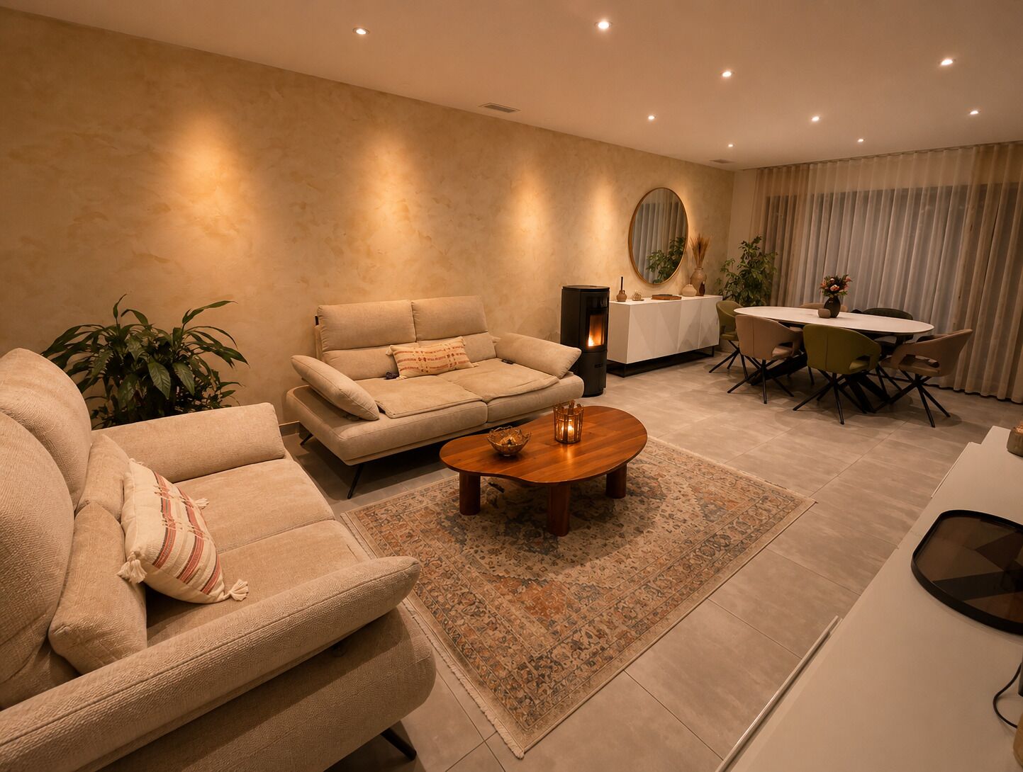 A modern living room with a sofa, coffee table, and dining area.