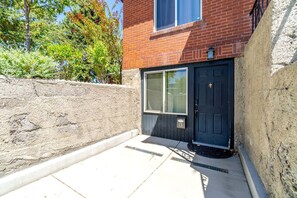 A residential building with a brick facade, a dark-colored front door, and a window above the door. - Cozy Studio with King Bed & Pet-Friendly Stay in Reno (Reno)