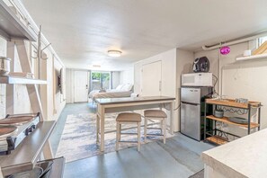 A compact kitchen with a dining area, a refrigerator, and a microwave. - Cozy Studio with King Bed & Pet-Friendly Stay in Reno (Reno)