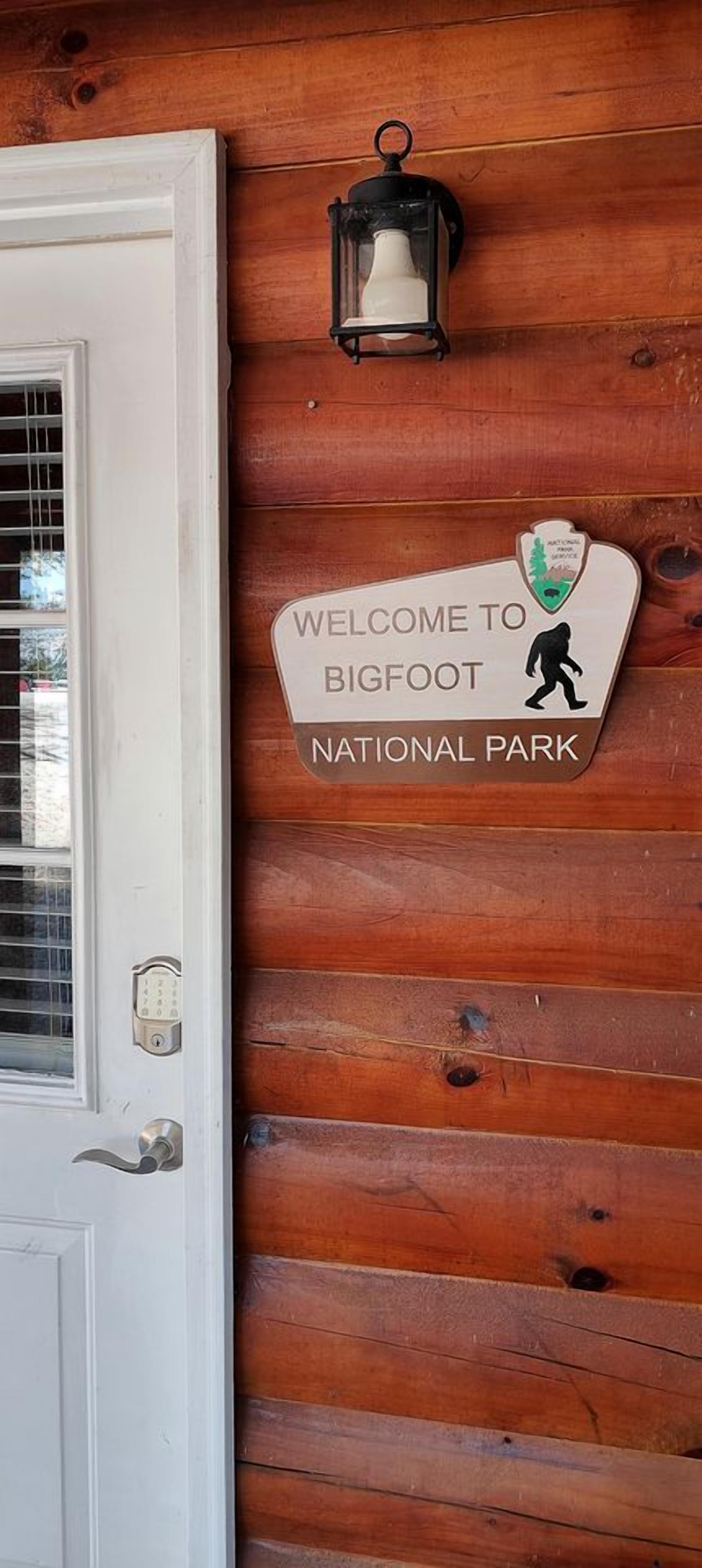 A wooden door with a welcome sign for Bigfoot National Park.