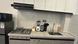 Keittiössä on kaasuliesi, mikroaaltouuni, pesuallas ja kaapistot.