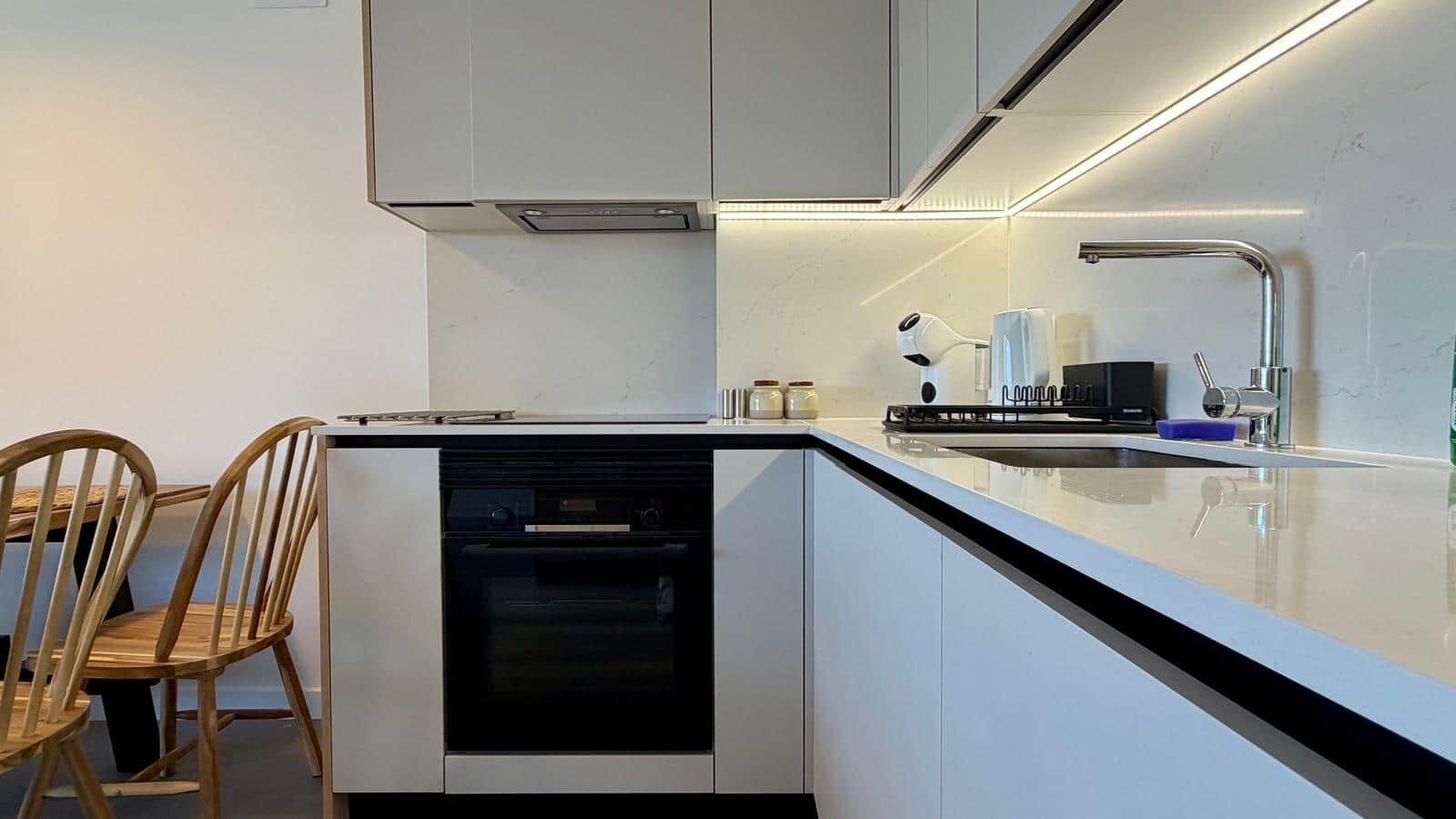Fridge, stovetop, paper towels, dining table