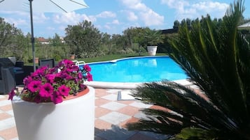 Seasonal outdoor pool, open 8:00 AM to 8:00 PM, pool umbrellas