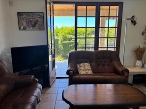 A living room with a television, leather sofa, and a coffee table. - Beachfront family villa with a pool, Domaine de Port d'Alon, sleeps 6–10 (Saint-Cyr-sur-Mer)