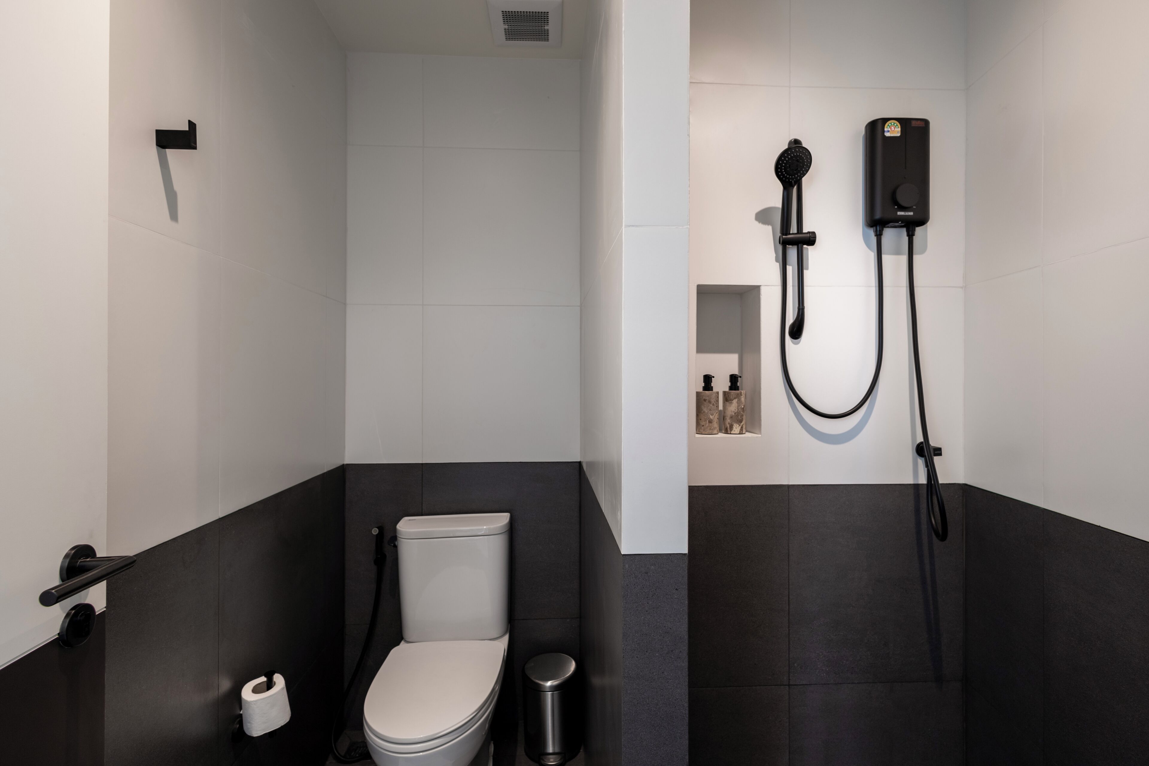 A modern bathroom with a toilet, bidet, and shower.