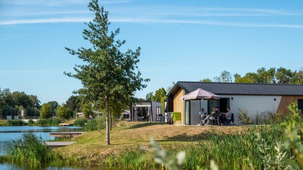 A lakeside property with a small building, outdoor seating, and a dock. - Holiday Home in Kampen With Terrace (Kampen)