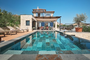 A modern two-story house with a swimming pool, outdoor seating, and a garden. - Luxury Seafront Villa Kaprije Šibenik with pool (Kaprije)