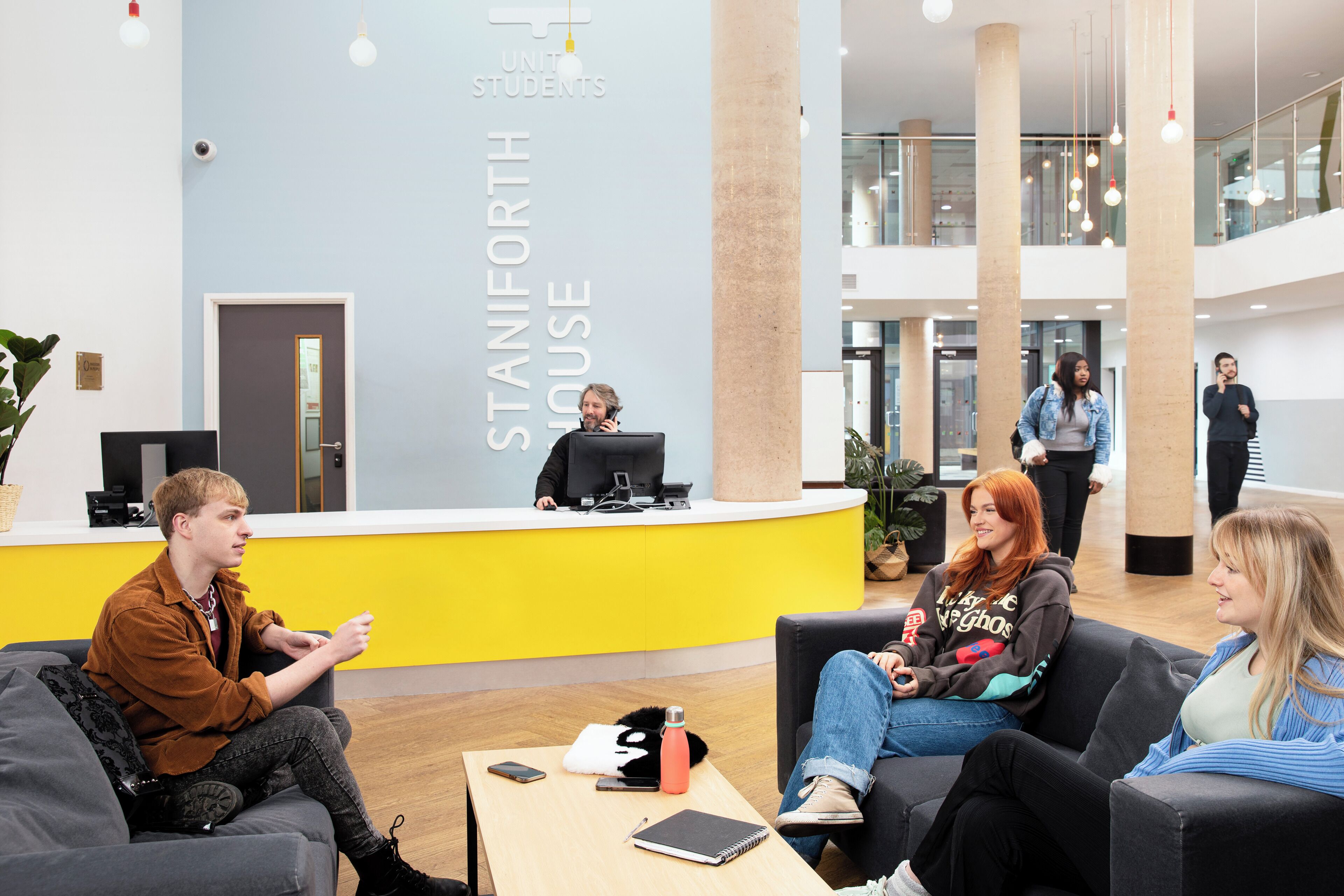 A reception area with a counter, seating, and a modern interior design.