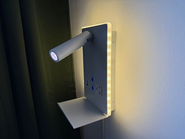 A wall-mounted light fixture with a cylindrical design and a flat base.