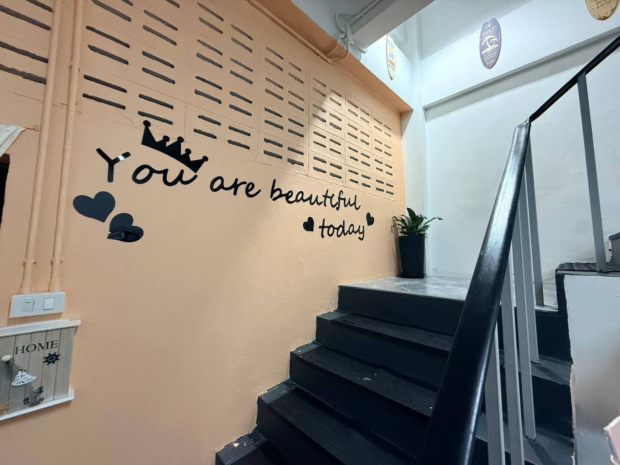 A staircase with a wall featuring a motivational quote and a crown graphic.