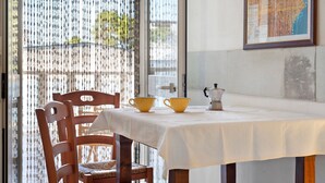 A dining area with a table, chairs, and a map on the wall. - Atenaion Studio Residence Holiday Home with Shared Terrace, Wi-Fi and Air Conditioning (Otranto)