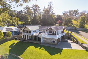 A two-story house with a balcony, a fenced yard, and a driveway. - The Barn at Berry. A luxury country escape (Berry)