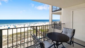 Ein Balkon mit Blick auf Strand und Meer.